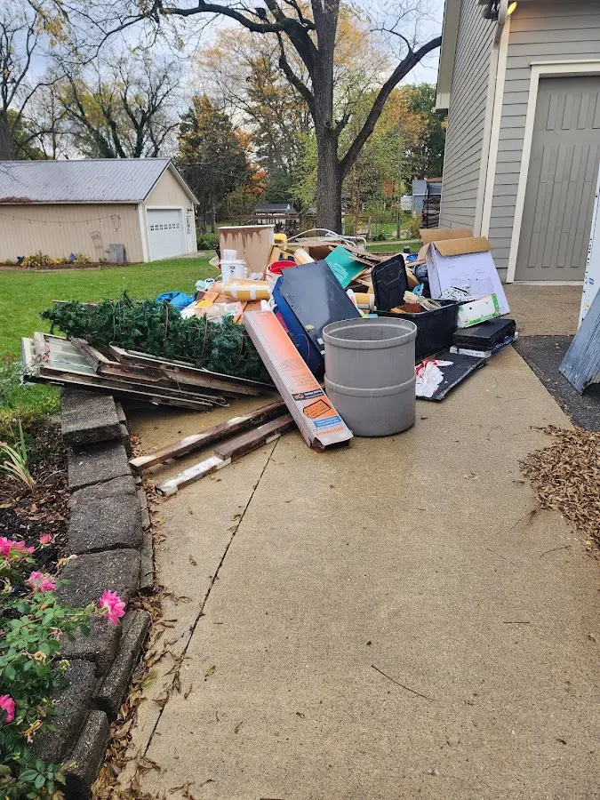 Dumpster being loaded with debris for Roofing Dumpster Rental in Middlesex